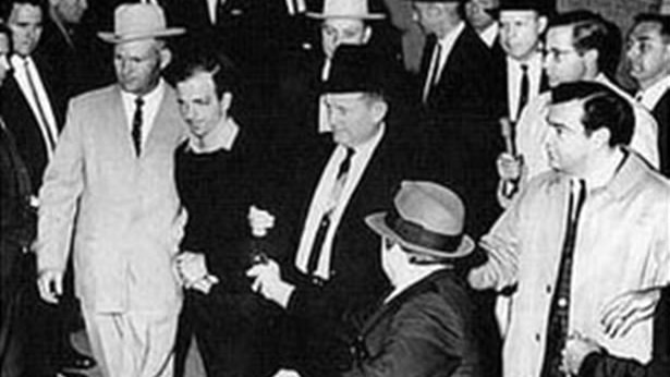 Lee Harvey Oswald is shot by Jack Ruby in the basement of Dallas Police Headquarters.