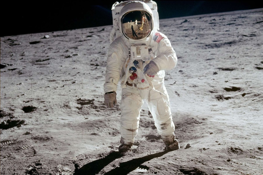 Buzz Aldrin walks on the surface of the moon during the Apollo 11 moonwalk.