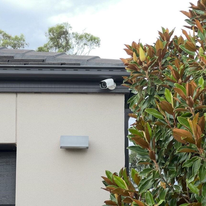 a photo of a security camera on someone's house, looking over the driveway 