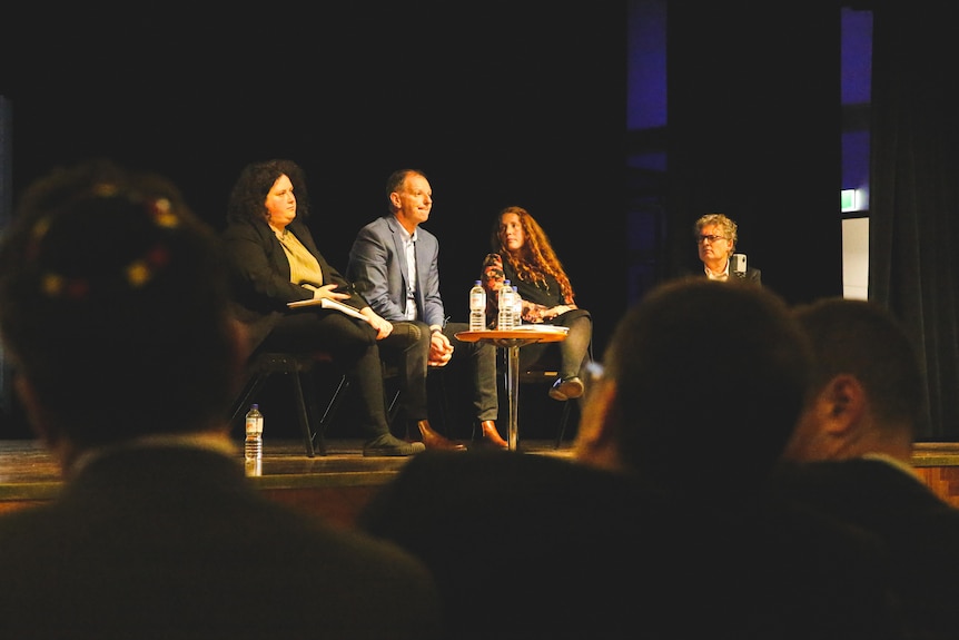 Four people on stage.