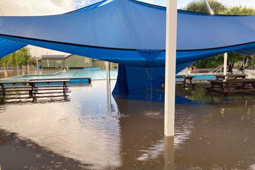 A flooded area in front of a swimming pool.