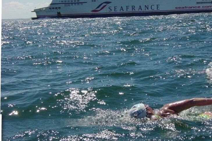 Anne Henderson swimming in the English Channel with a Sea France ship in the background