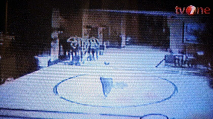 Unconfirmed CCTV footage: a suspected suicide bomber walks through a hotel in Jakarta.