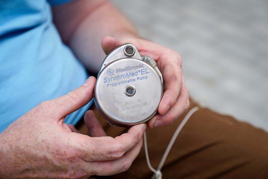 A close-up of a round, silver pump which can be implanted inside people to help with pain relief.