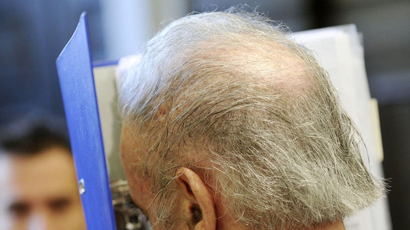 Josef Fritzl hides his face from media on the way to the courthouse