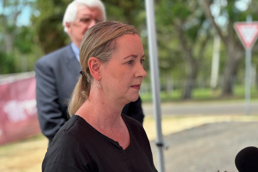 A woman standing and speaking during a press conference