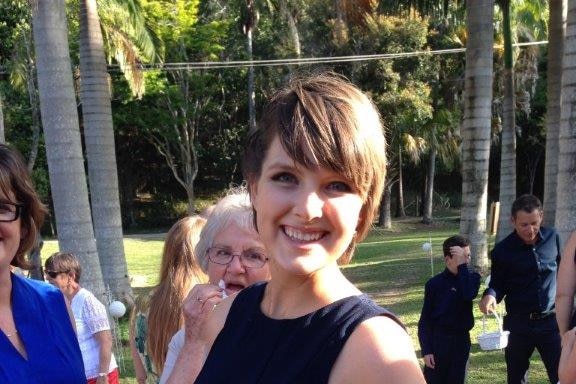 A photo of Kathryn Woods wearing a black dress, smiling.
