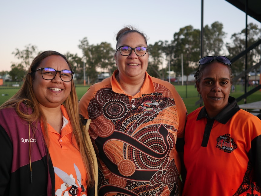 Luella Blair, Lynette Brown (President), Kimberley Barret at the football field. 