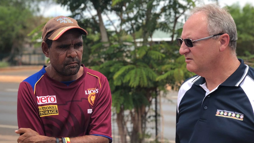 Two men speak on a street in Tennant Creek