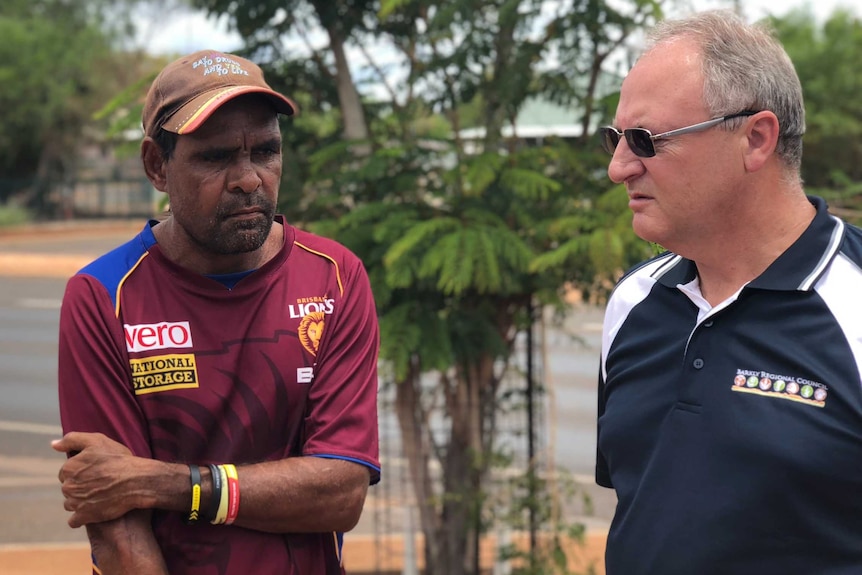 Two men speak on a street in Tennant Creek