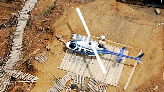 A Bell 206 helicopter owned by the transport company Hevilift sits of the ground.