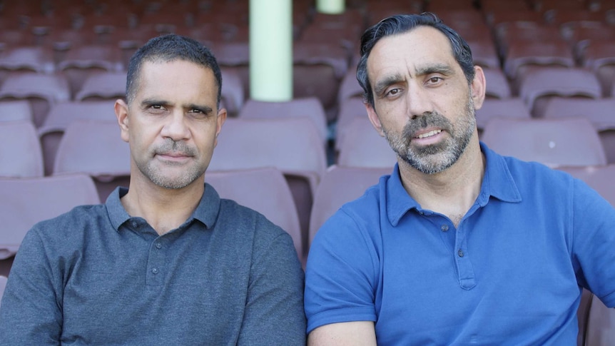 Michael O'Loughlin and Adam Goodes sit on stadium seating