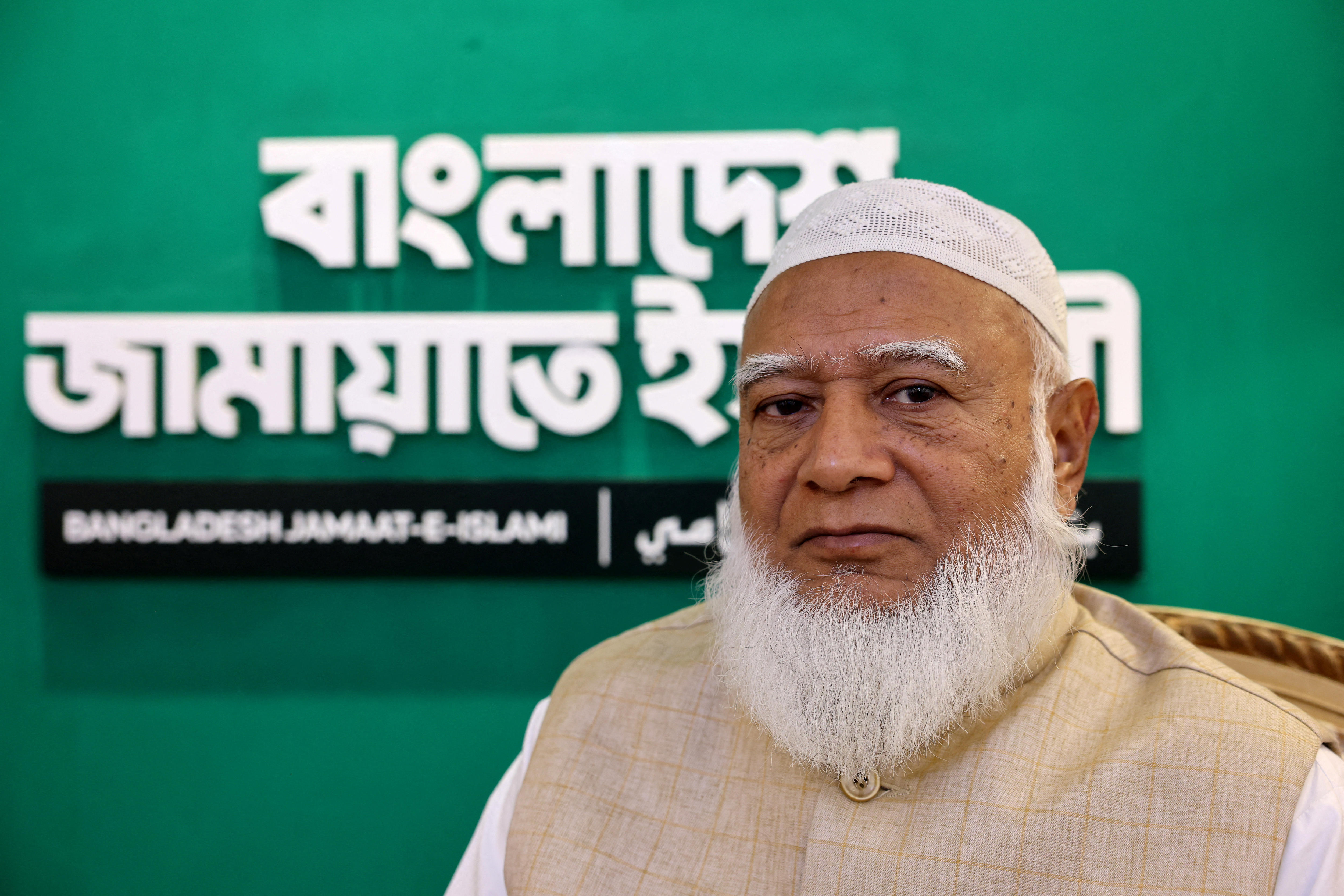 A close up of a Bangladeshi man with a white beard.