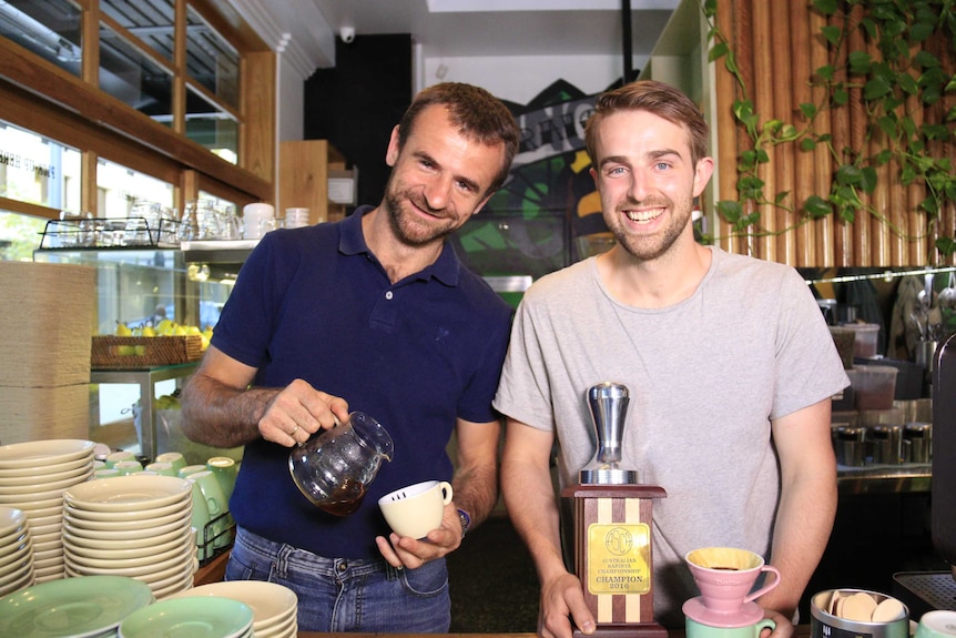 The pair smile while Sasa Sestic pours coffee.