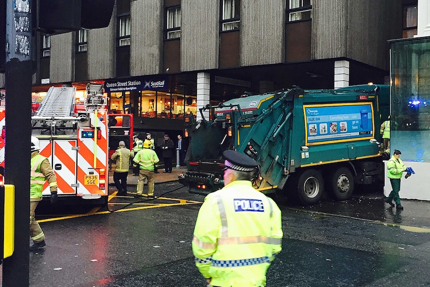 A rubbish truck is seen wedged into the wall of the Millennium Hotel in George Square in central Glasgow