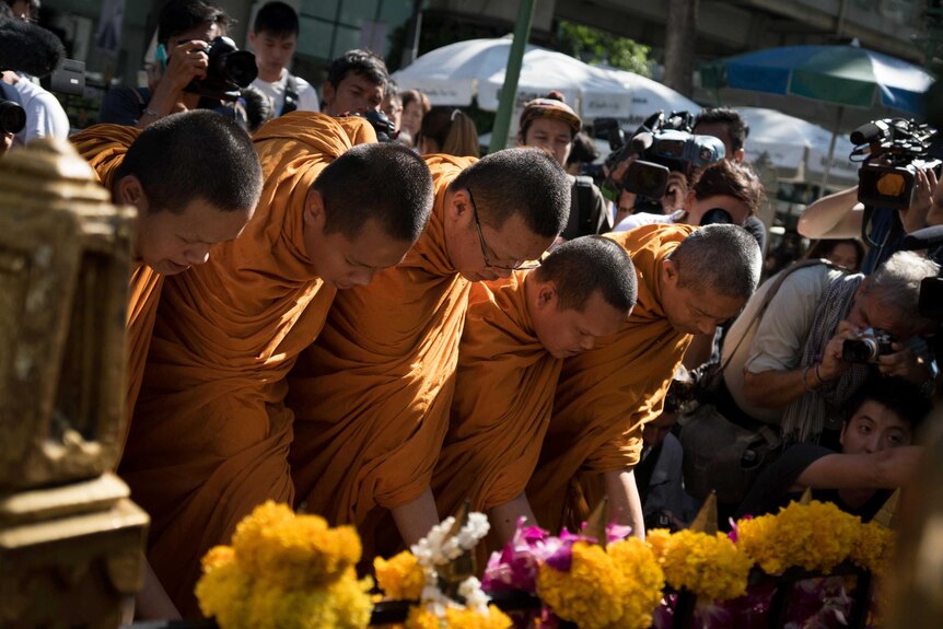 Monks make offerings at the reopened Erawan shrine in Bangkok on 19 August 2015.