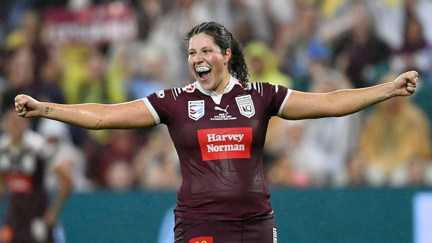 Queensland Maroons prop Chelsea Lenarduzzi holds her arms out after winning Women's State of Origin III.