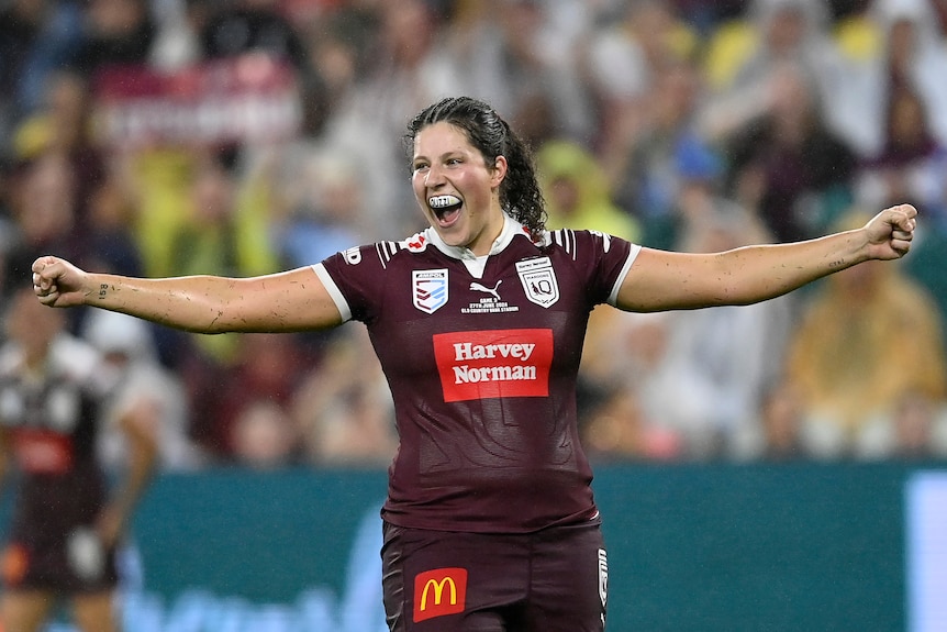 Queensland Maroons prop Chelsea Lenarduzzi holds her arms out after winning Women's State of Origin III.