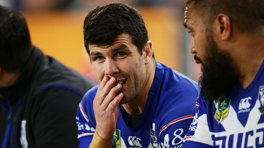 Foot injury ... Michael Ennis looks on from the bench against the Panthers