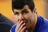 Foot injury ... Michael Ennis looks on from the bench against the Panthers