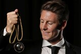 Top gong ... Nathan Burns poses with the Johnny Warren Medal