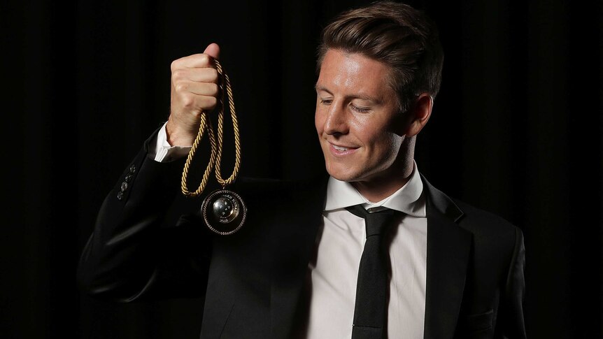 Top gong ... Nathan Burns poses with the Johnny Warren Medal