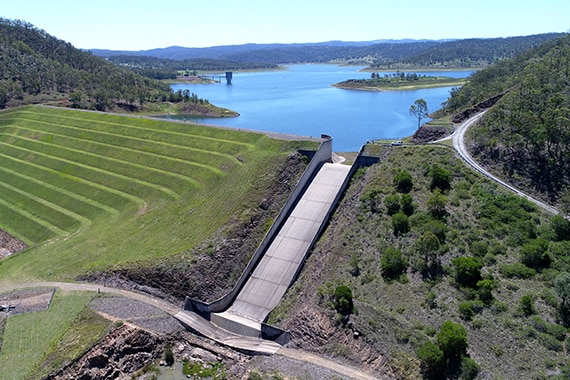 A dam, as seen from above, on a clear day.