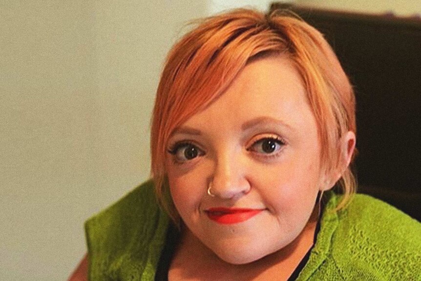 Portrait of Stella Young wearing a green shirt.