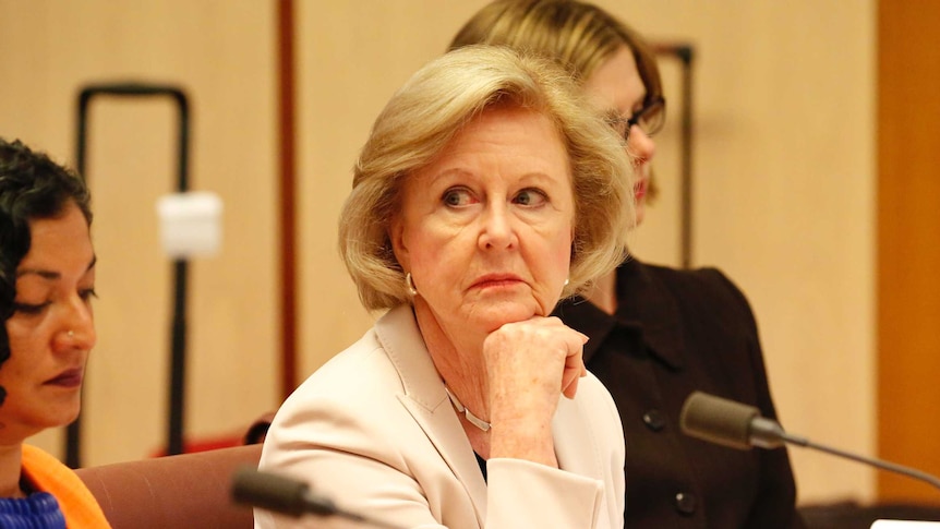 Gillian Triggs looks displeased with her chin on her hand during a Senate Committee hearing.