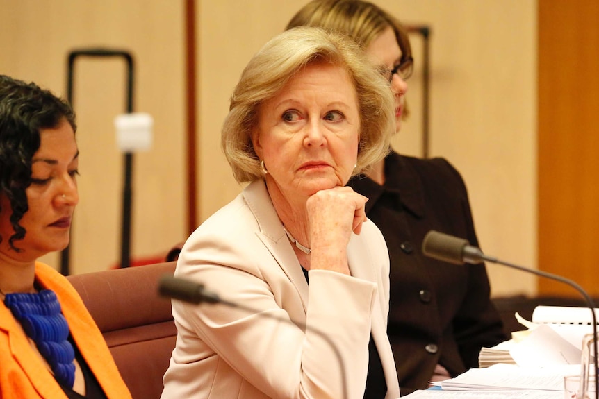 Gillian Triggs looks displeased with her chin on her hand during a Senate Committee hearing.