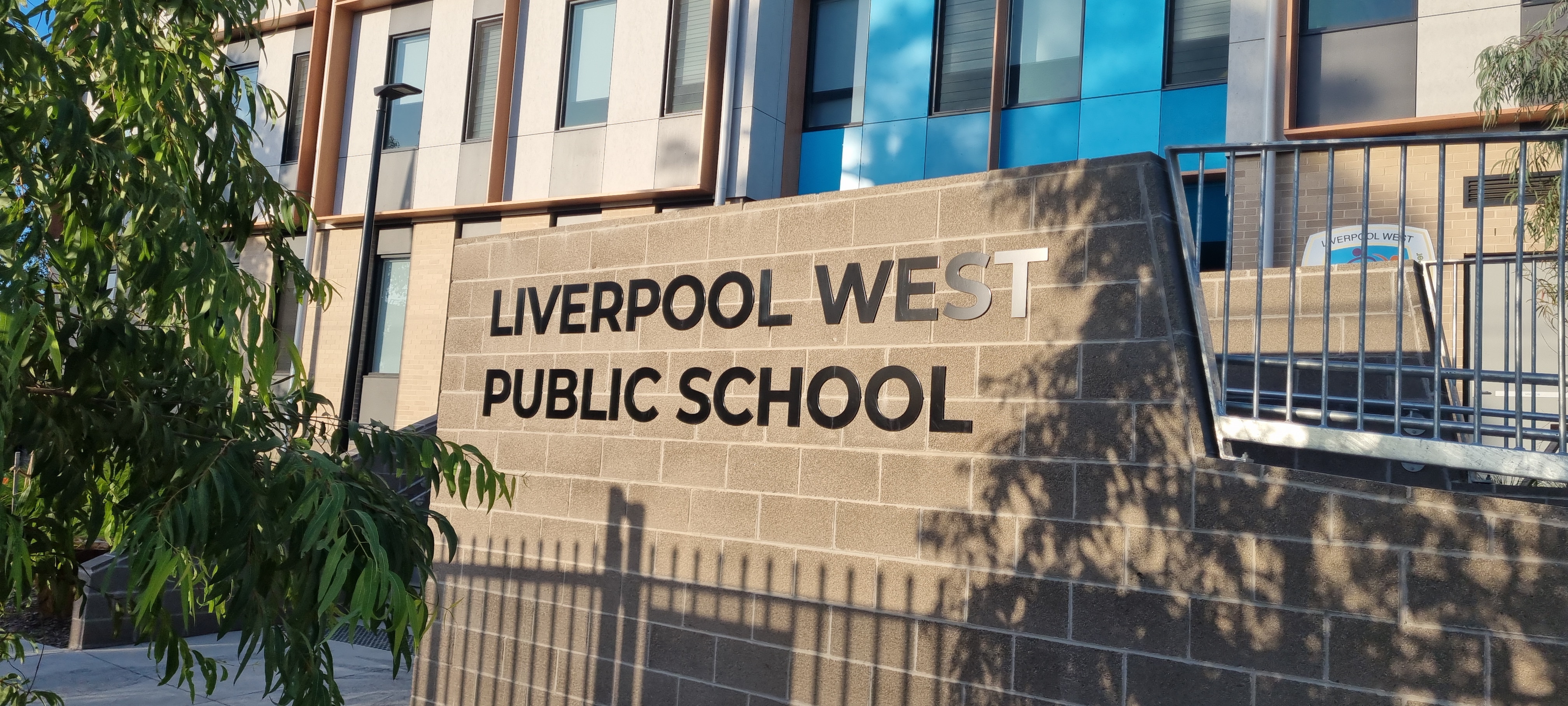 Front sign of Liverpool West Public School on brick