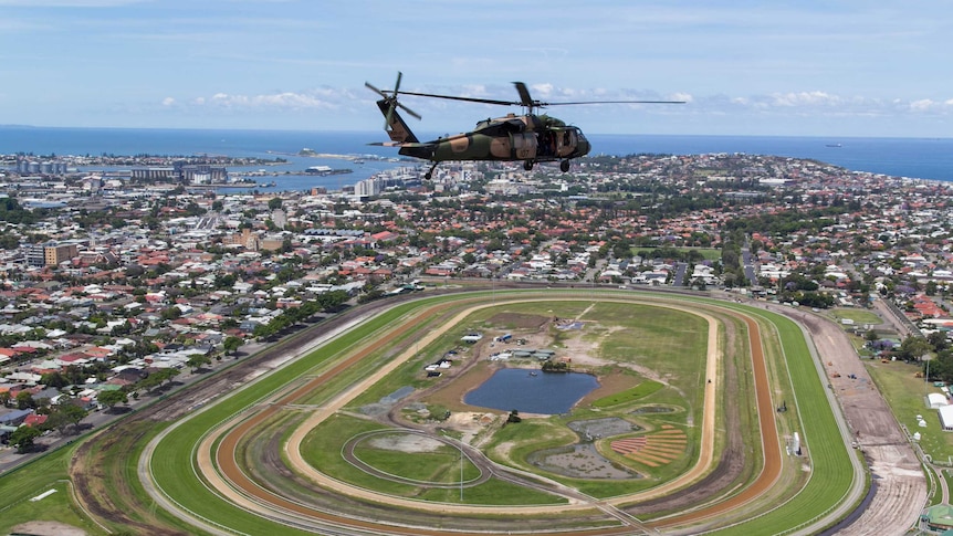 A Black Hawk helicopter flies over Broadmeadow Racecourse.