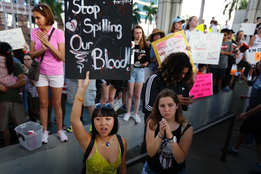 Teen holds placard in Florida