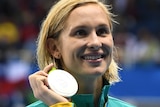 Australian swimmer Maddie Groves holds up her silver medal at the 2016 Rio Olympic Games after the 200 metres butterfly final.