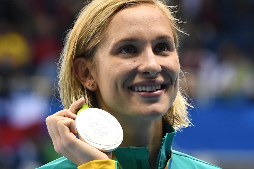 Australian swimmer Maddie Groves holds up her silver medal at the 2016 Rio Olympic Games after the 200 metres butterfly final.