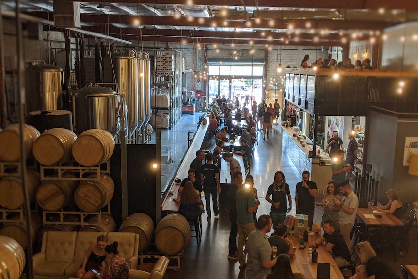 A crowd of people at a microbrewery.