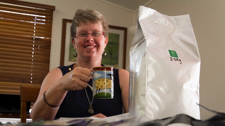 Wendy Phelps sitting at her kitchen table with a cup of tea.