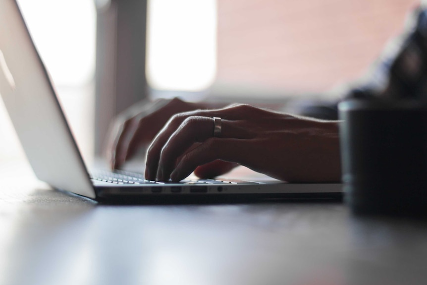 Person typing on laptop