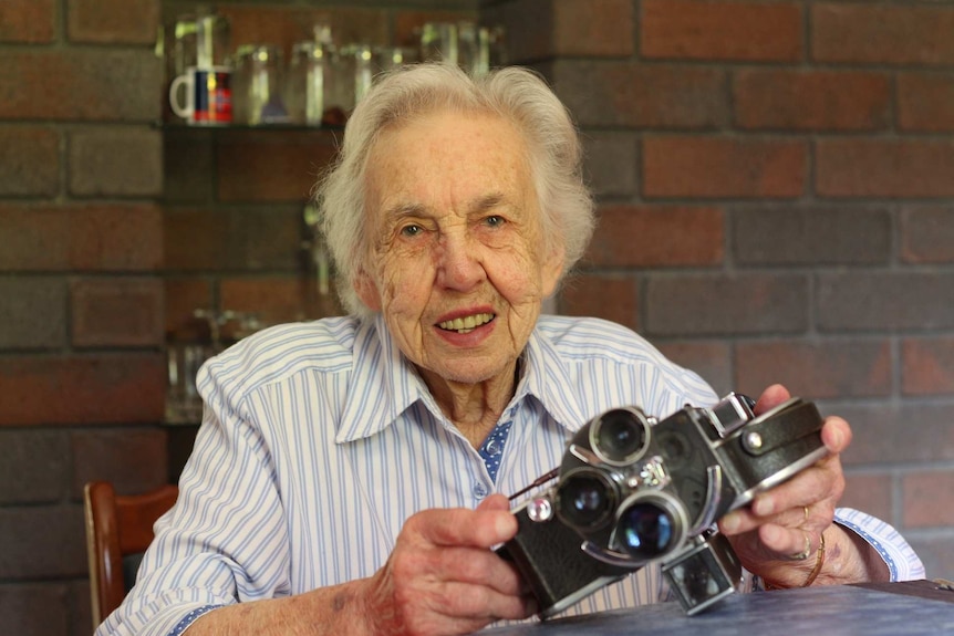 Dorothy Hallam holds her camera.