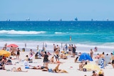 Hundreds of tourists and locals flock to Gold Coast beach