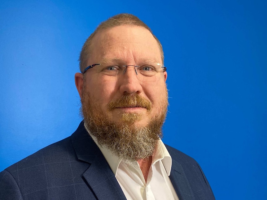 Headshot of Deaf Australia CEO Kyle Miers, he looks into the camera.