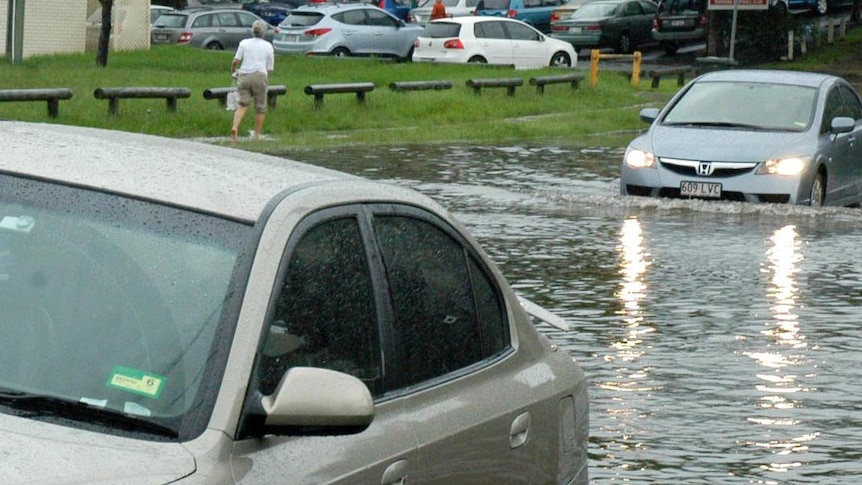 Cars make their way through floodwaters
