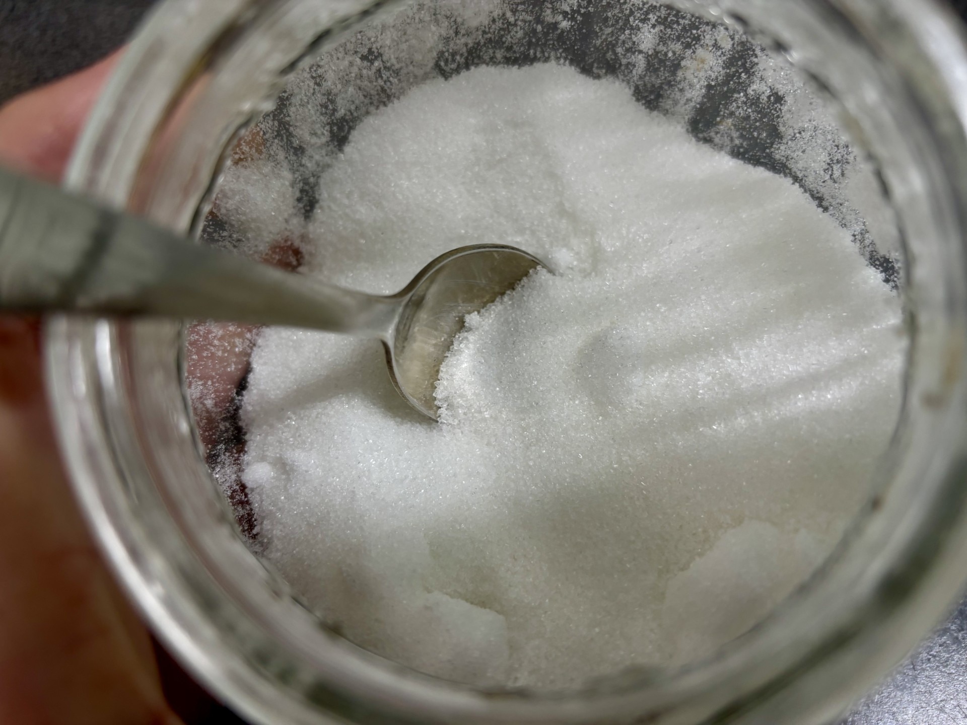 White sugar is a jar with a spoon.