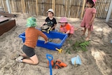 Children playing in a sandpit. 