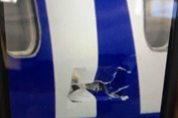 Damage to the fuselage of a Southwest plane that was able to land safely after suffering engine damage on August 27, 2016.