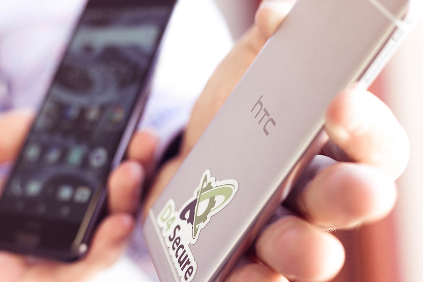 A thin, metallic HTC secured by D4 smartphone, close up.