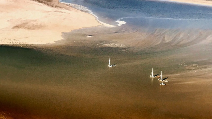 Little white boats follow the flood waters from Queensland to Lake Eyre