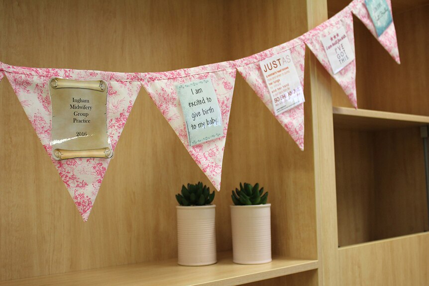 Floral bunting with inspirational quotes about birthing on it
