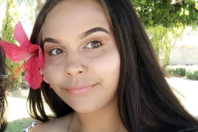 Linda Cockie is pictured with a flower tucked behind her ear.