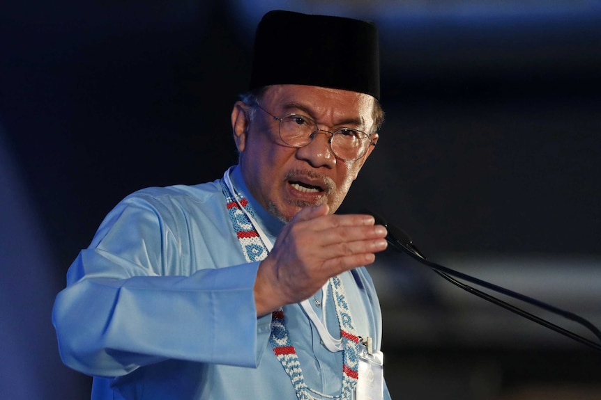 Anwar Ibrahim gestures as he gives a speech.